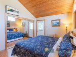  The bedroom also has access to the large wrap-around deck and includes a TV.
